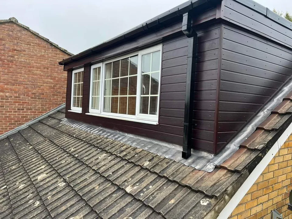 Finished dormer with dark cladding and roof-edge details