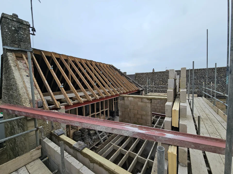 New timber roof framing installed over existing stone walls